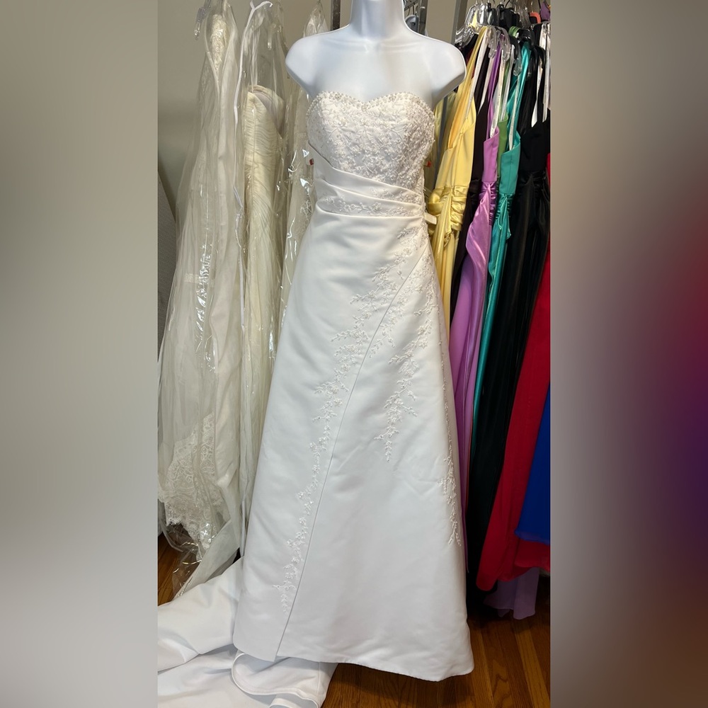White satin A-line with embroidery and side drape.